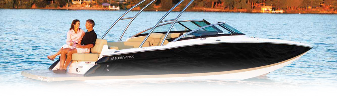 couple sitting on a four winns boat